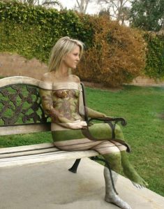 Invisible naked blonde girl outdoors on a bench