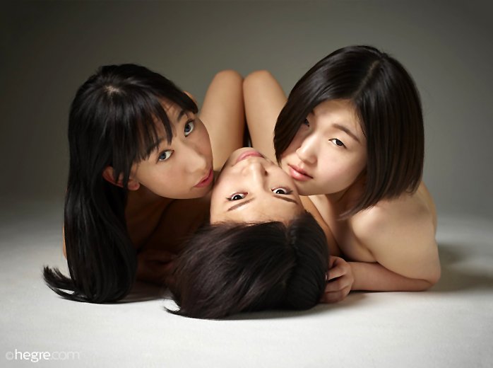 Three beautiful Asian dols sensually pose naked together