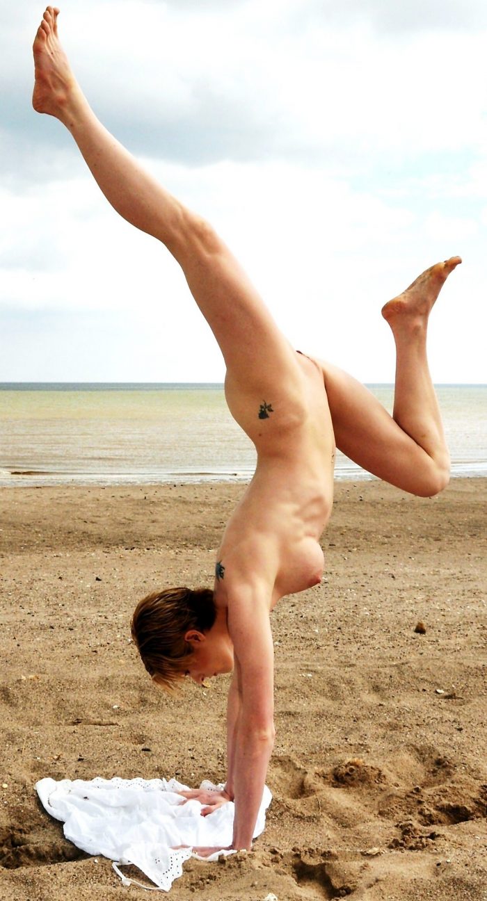 Flexible tattooed girl naked on the beach SexPin image