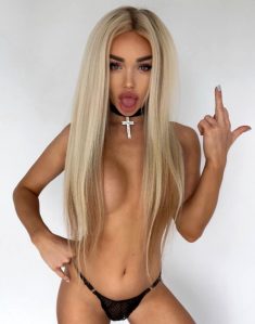 Amazing blonde Barbie Eva unveils her big tits while teasing in lingerie